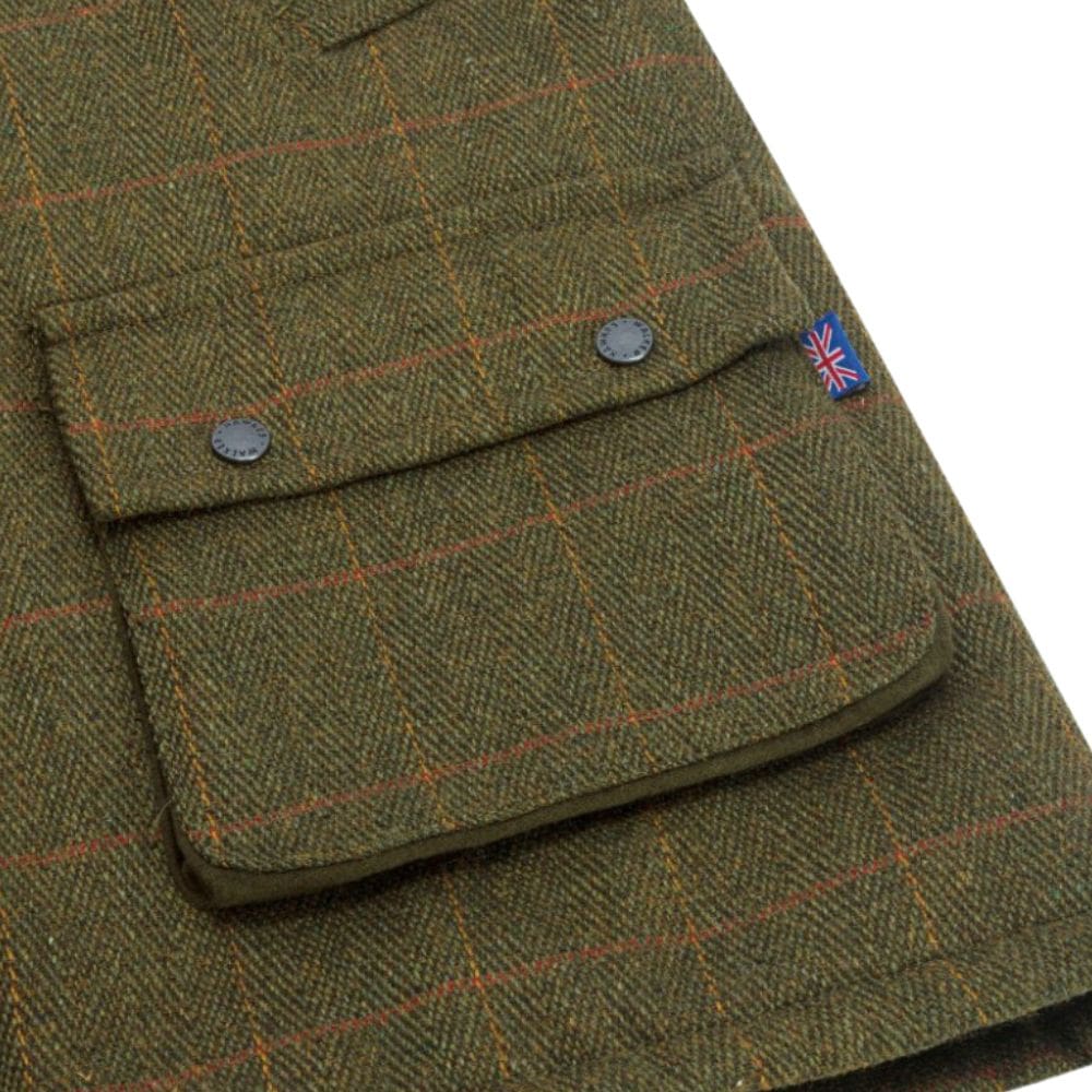 Detail stof en zak van de tweed waistcoat groen