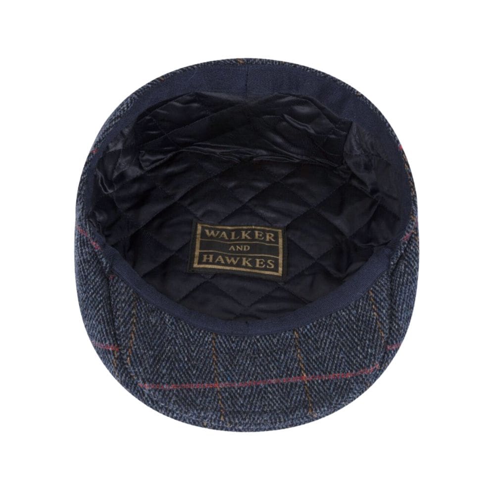 blauwe tweed flatcap van binnen gefotografeerd